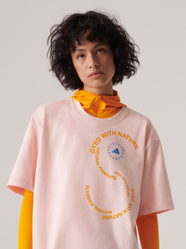 A female model wears the new t-shirt SS23 adidas by Stella McCartney gender-neutral loungewear drop. Crafted from 100% organic cotton.