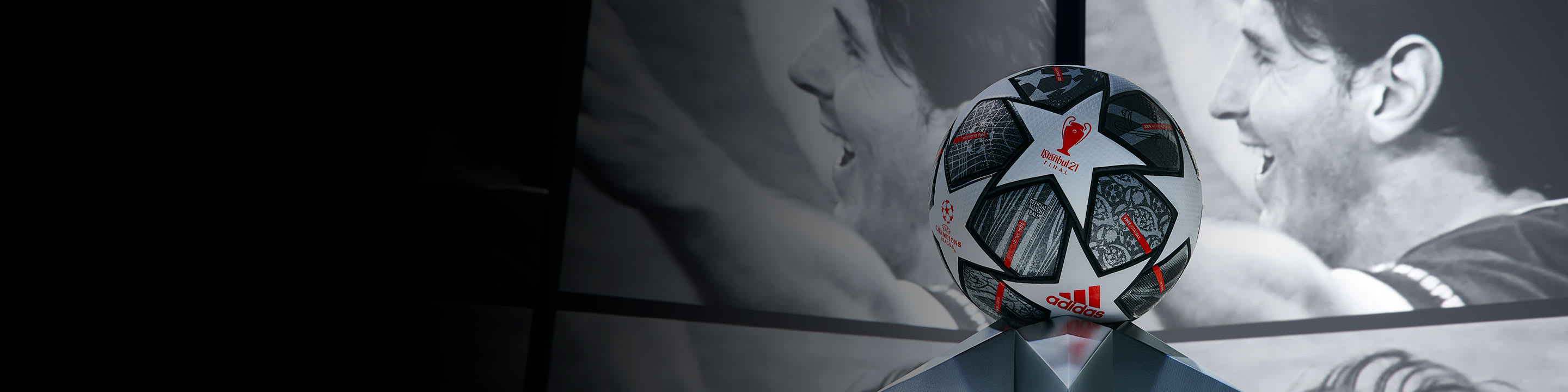 ball on plinth surrounded by screens featuring messi