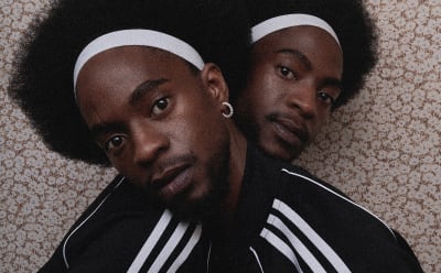 Two men are photographed wearing adidas Originals track jackets.