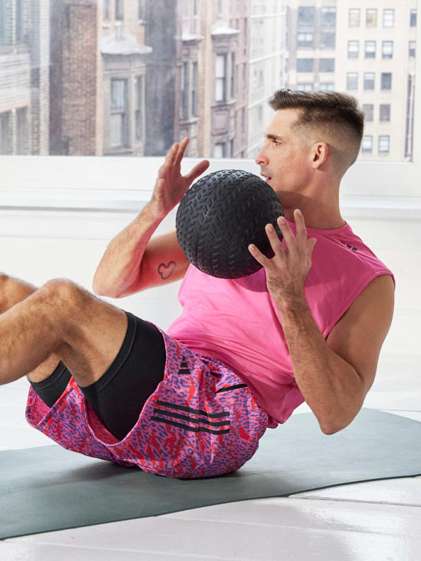 Celebrity HIIT instructor Cody Rigsby in the latest adidas training collection with colorful overlaid illustrations.