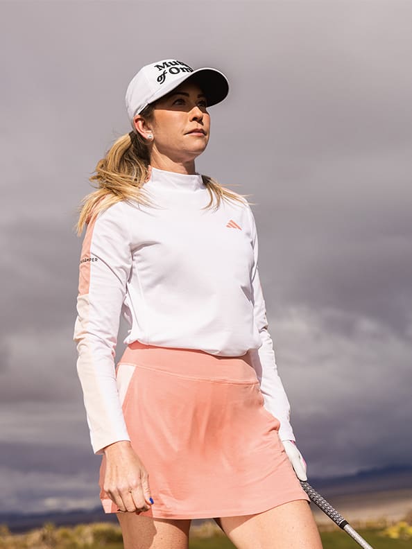 Paula Creamer looks at her shot on a golf course.
