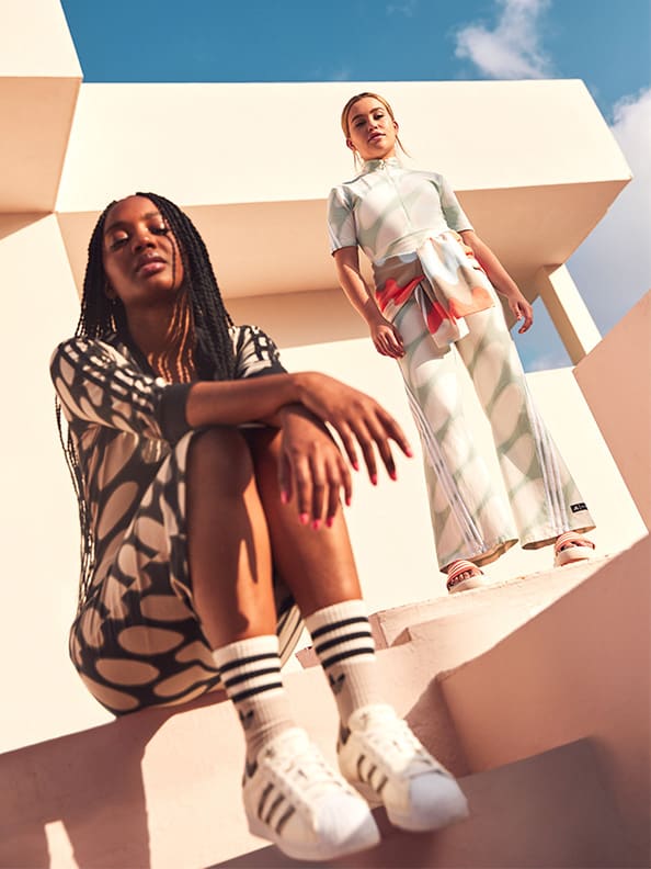 Two women on stair, wearing the adidas x Marimekko collection.