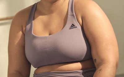 Image of a model’s chest wearing a lavender light support sports bra