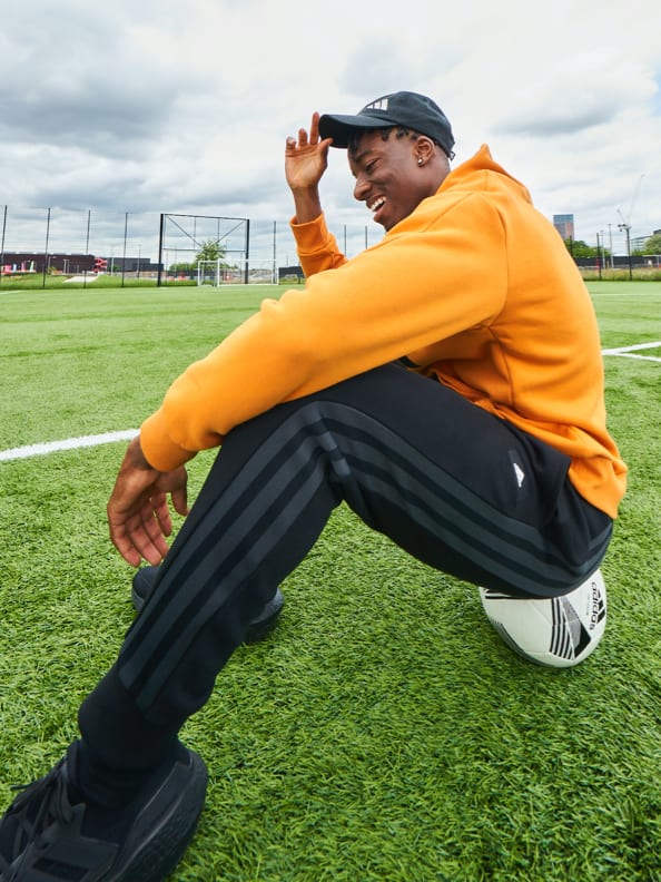 WNBA player Erica Wheeler and English footballer Noni Madueke wear adidas clothing with the iconic three stripes.