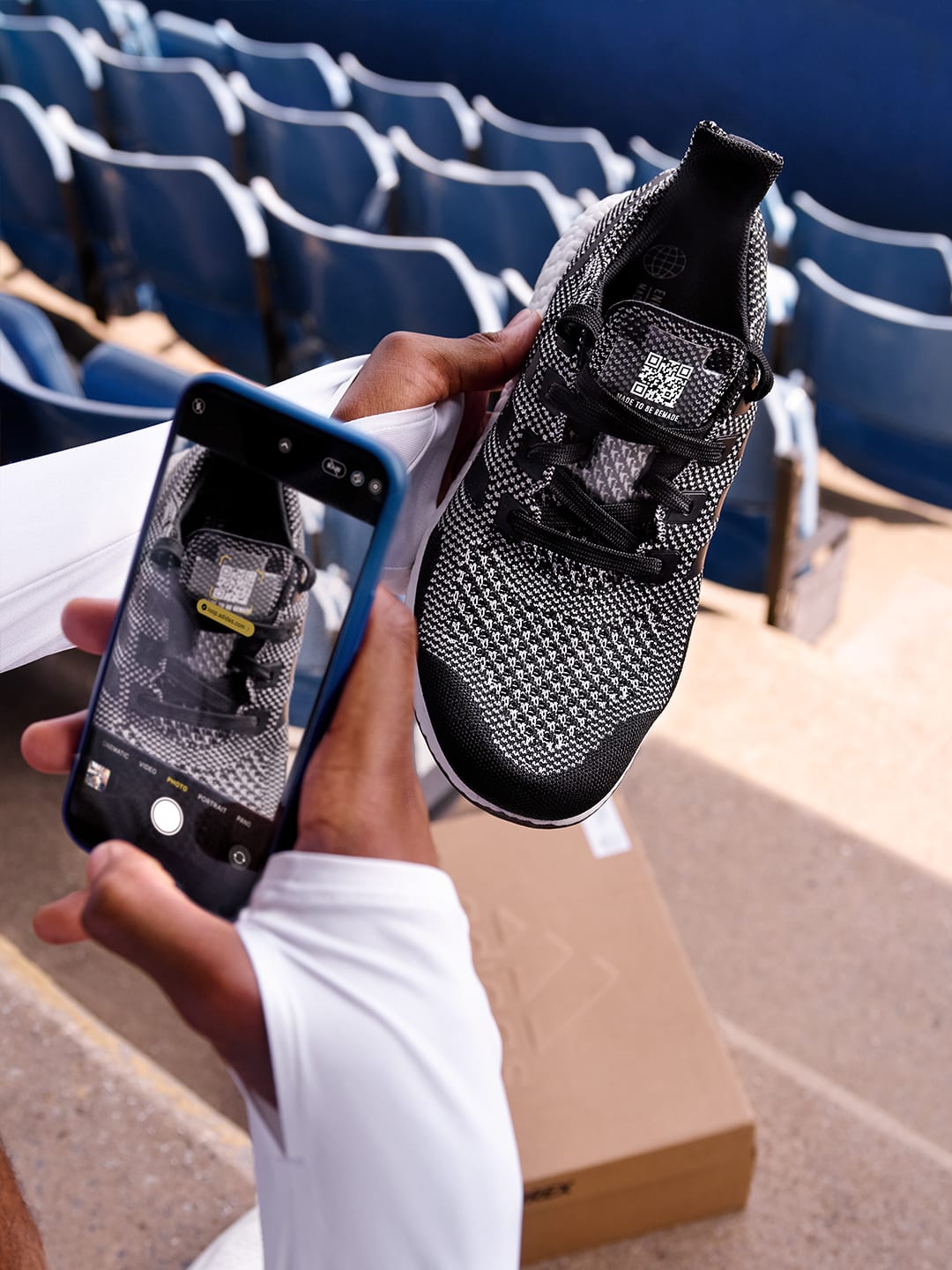 A person scanning the QR code on a Made To Be Remade shoe.