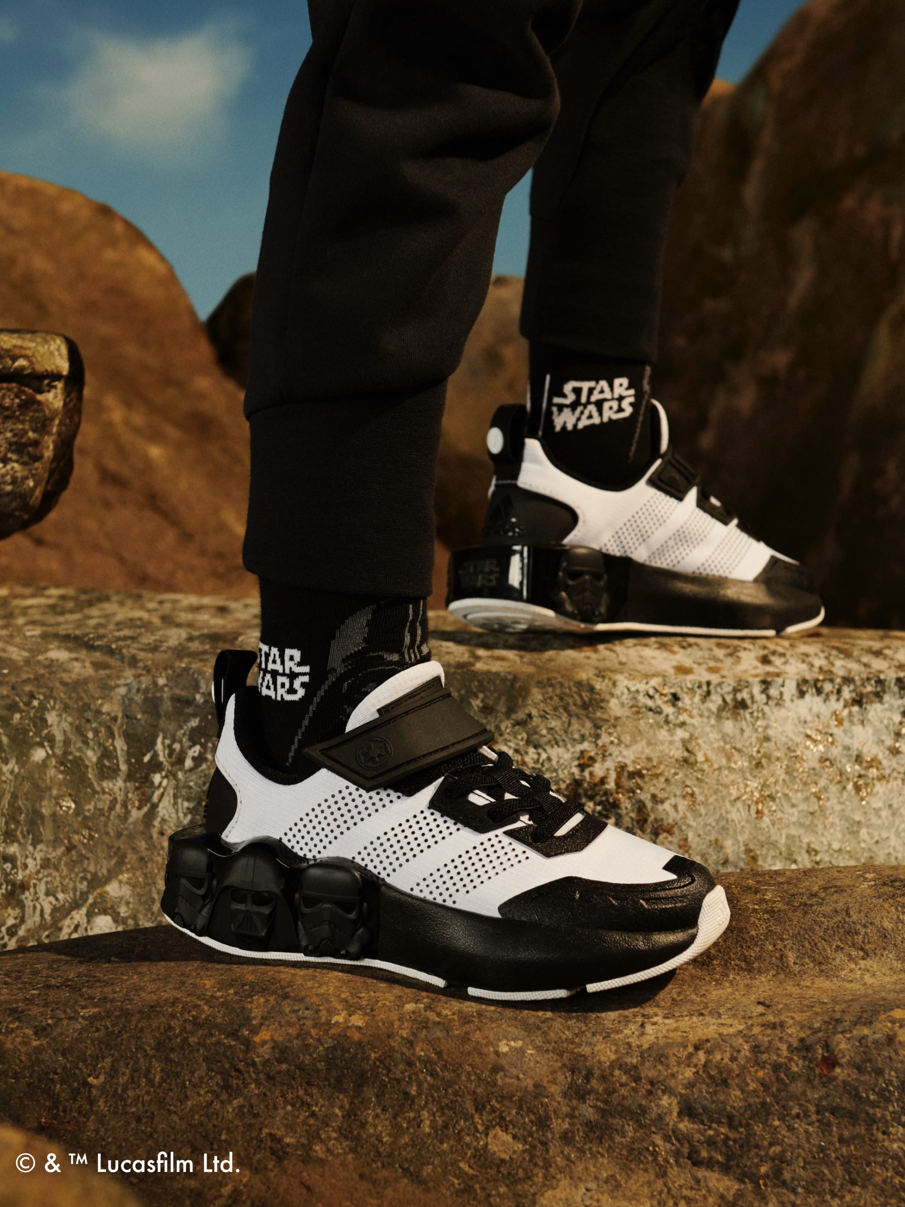 Focus on one foot standing on rock wearing the adidas | Star Wars collection
