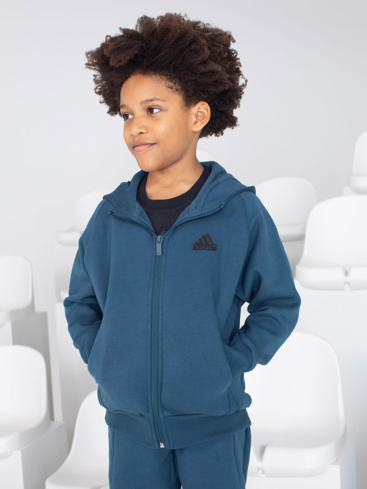 Child model wears Z.N.E. Sportswear bottoms.