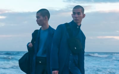 Male twins in Y-3 suits standing on the Japanese coastline