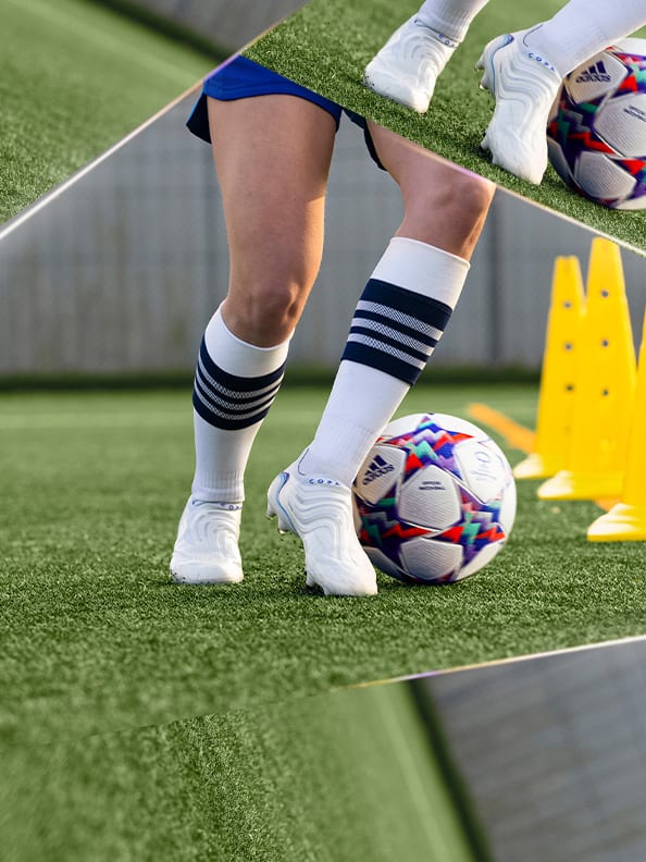 Image of player with white socks and the ball, yellow cones on the pitch, doing dribbling exercises.