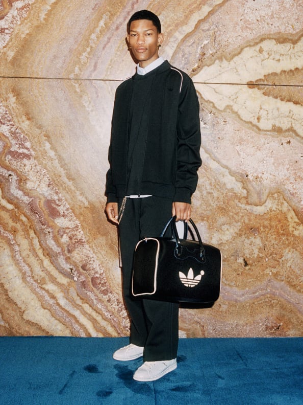 A model styled with Stan Smith x Blue Version