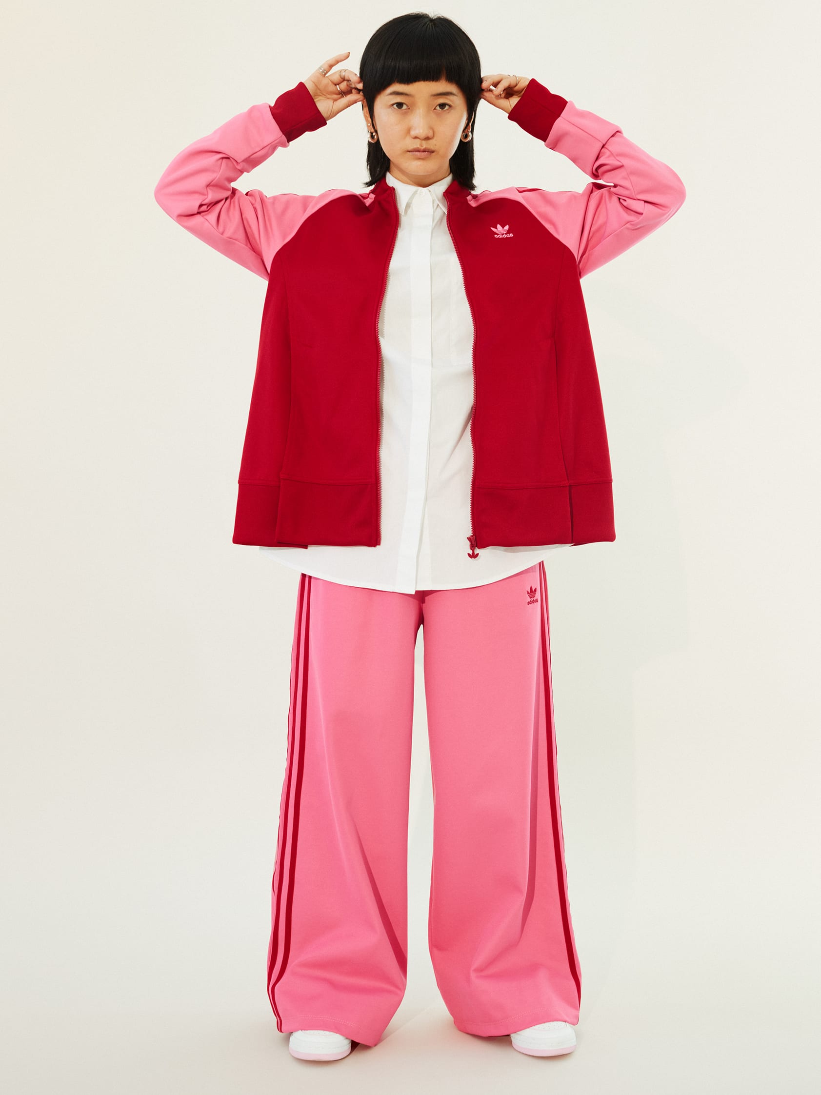 Stylish men and a woman pose in classic, bold and contemporary adicolor outfits.