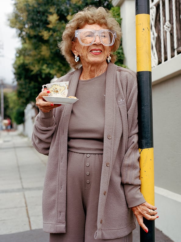 a stylish granny wearing loungewear and sipping a tea