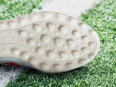 An outsole of an adidas football boot made to be played on turf