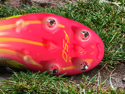 An outsole of an adidas football boot made to be played on soft ground