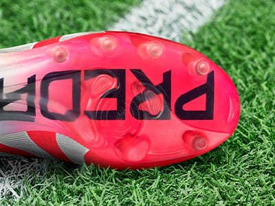 An outsole of an adidas football boot made to be played on artificial grass