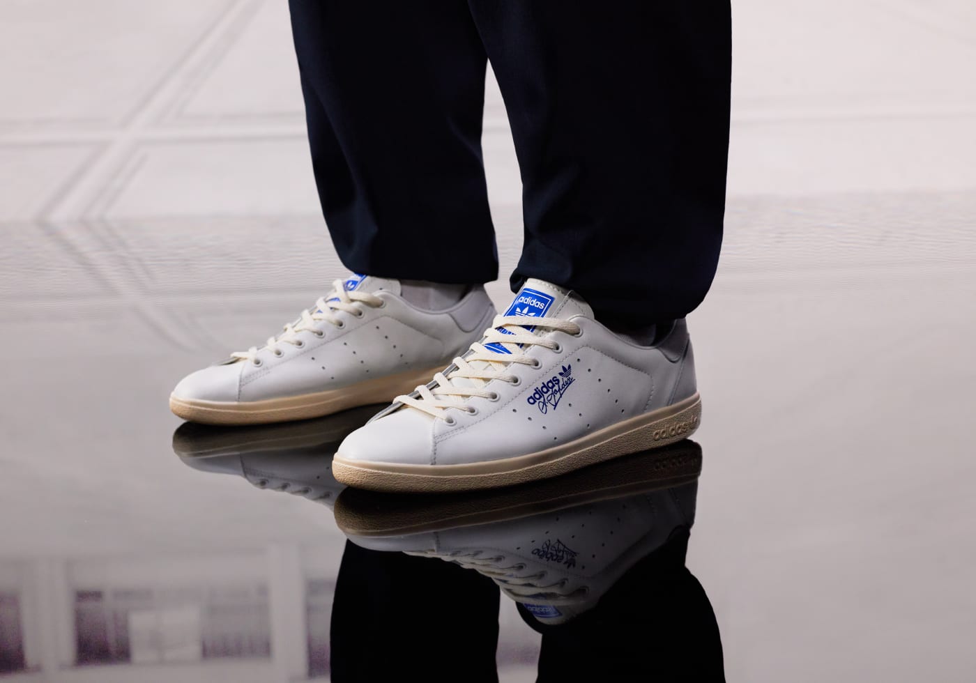 A photograph showing the A.Aspden SPZL trainer with its reflection in a pool of water.