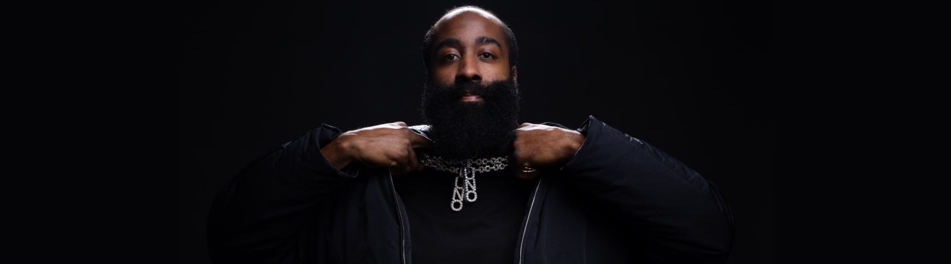 Close-up of James Harden facing camera in dark environment