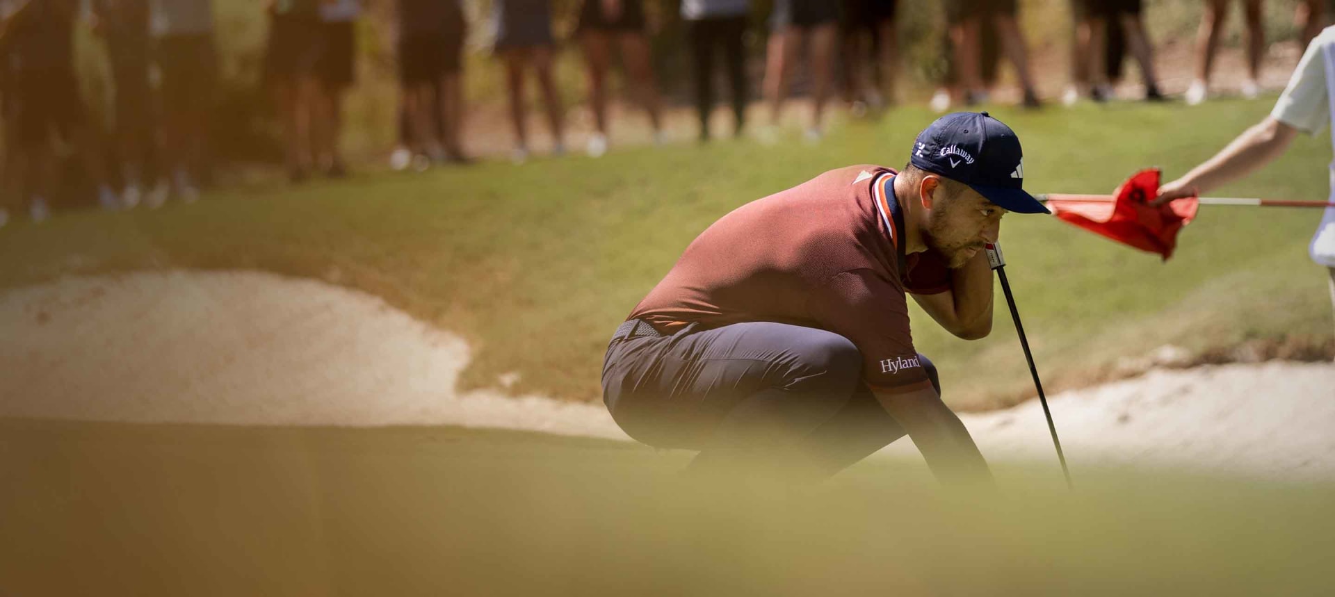 Professional Golfer, Xander Schauffele lines up a putt wearing ULTIMATE365 TOUR apparel.
