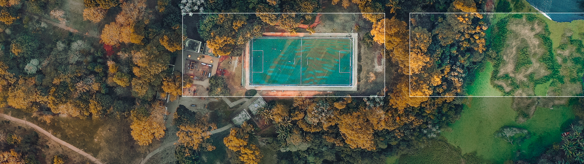 A birds eye view of a football pitch in a woodland.