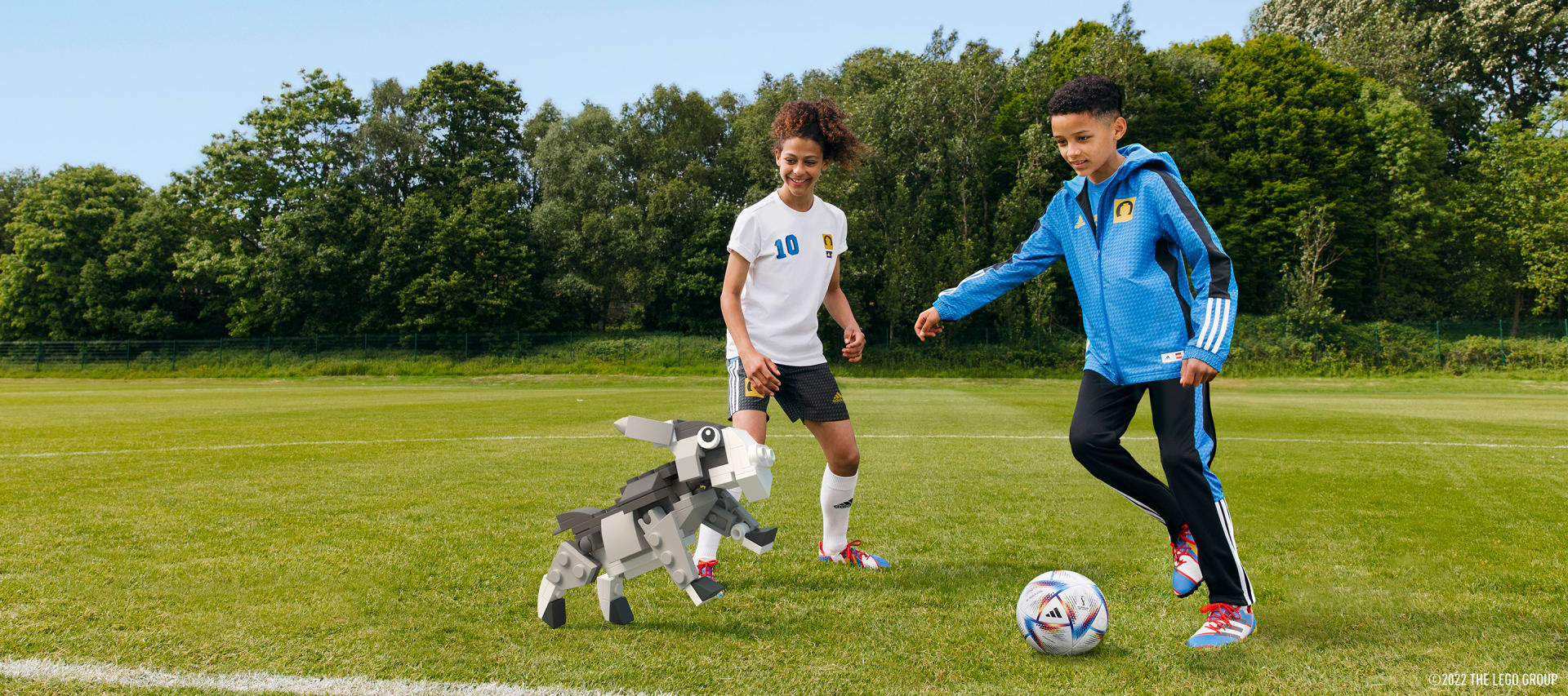 Kids playing football with a goat