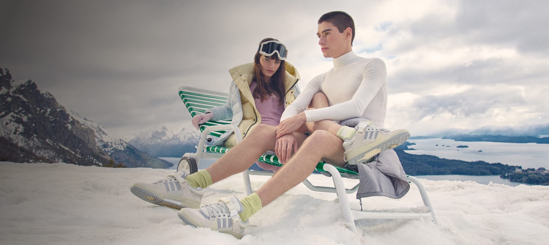 Two models in the snow wearing the Bad Bunny White Forums.