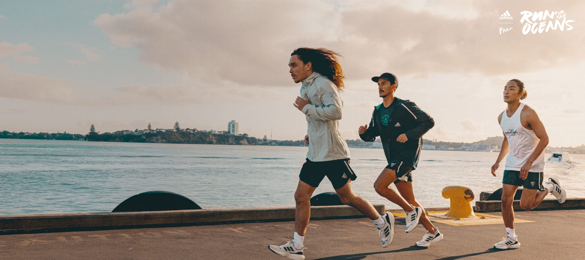 Group of men running by the ocean