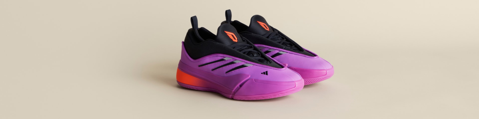 Close-up of two purple and black Dame 9 basketball shoes on light floor