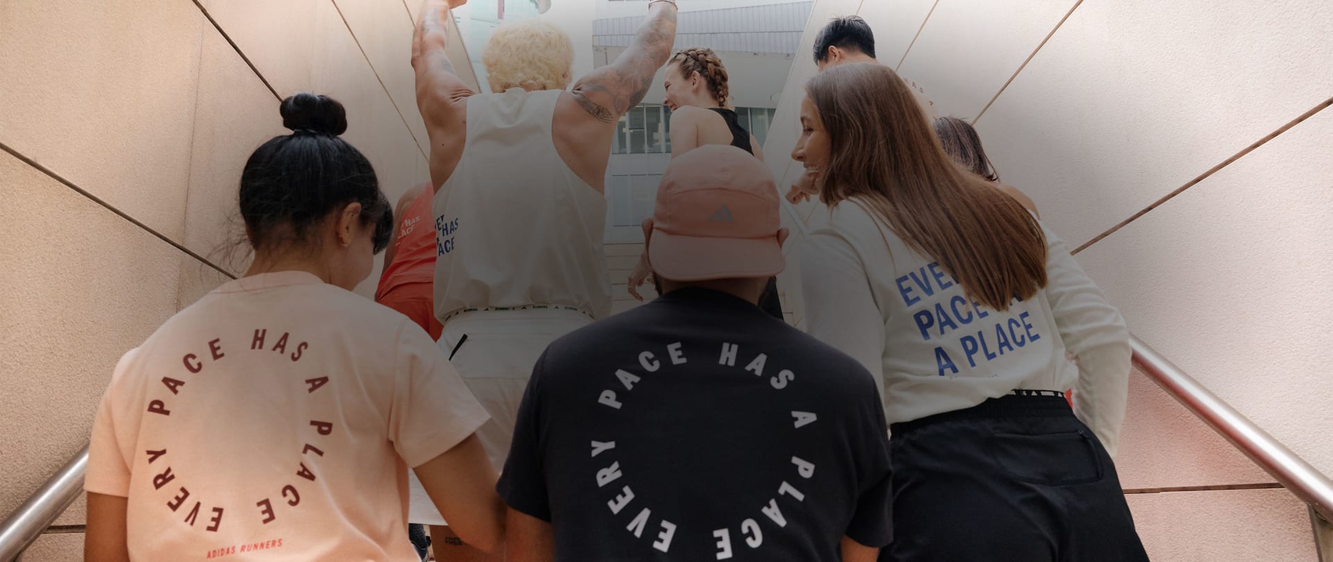 A group of people from behind walking up stairs and interacting with each other