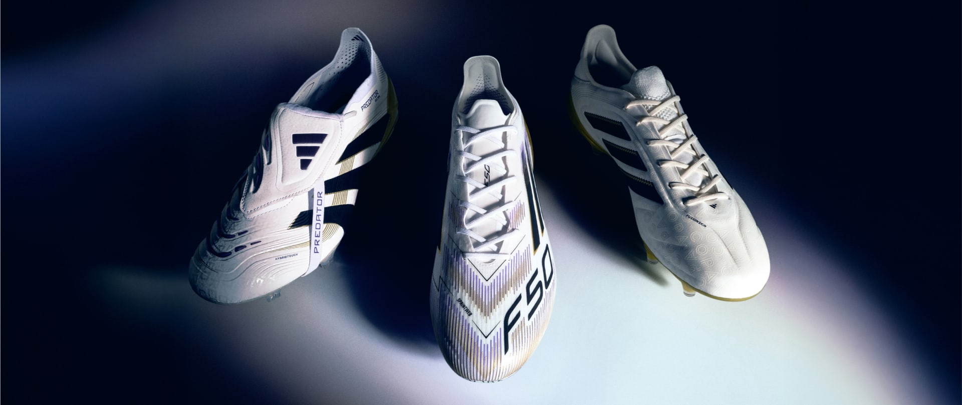 Three pairs of white and gray soccer boots with distinctive designs and patterns are displayed against a dark background, creating a striking visual contrast.