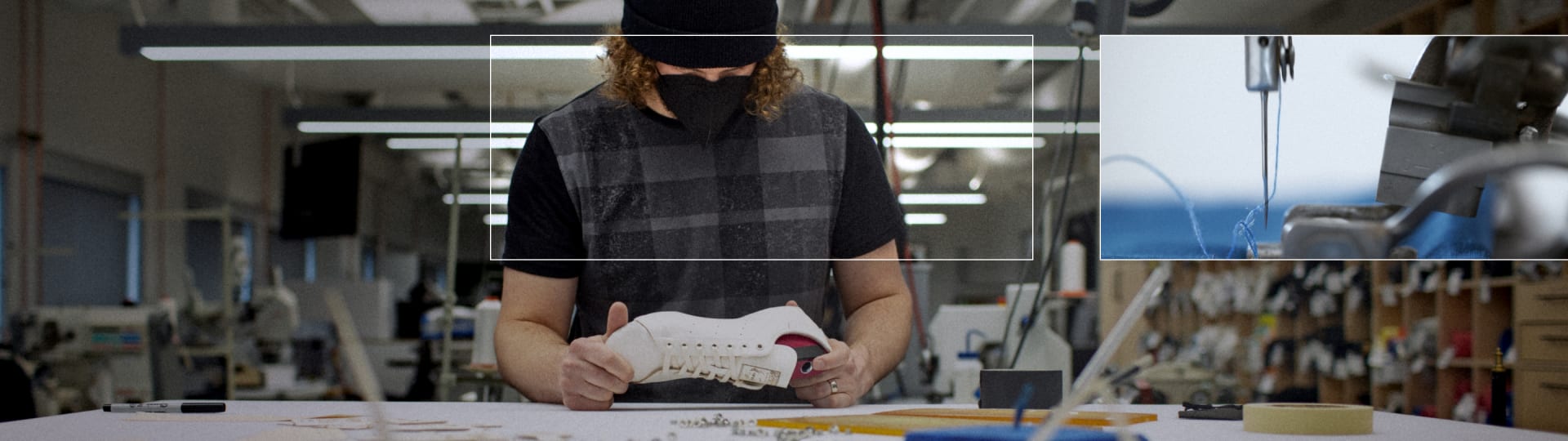 Someone in a factory doing quality checks on a Stan Smith shoe