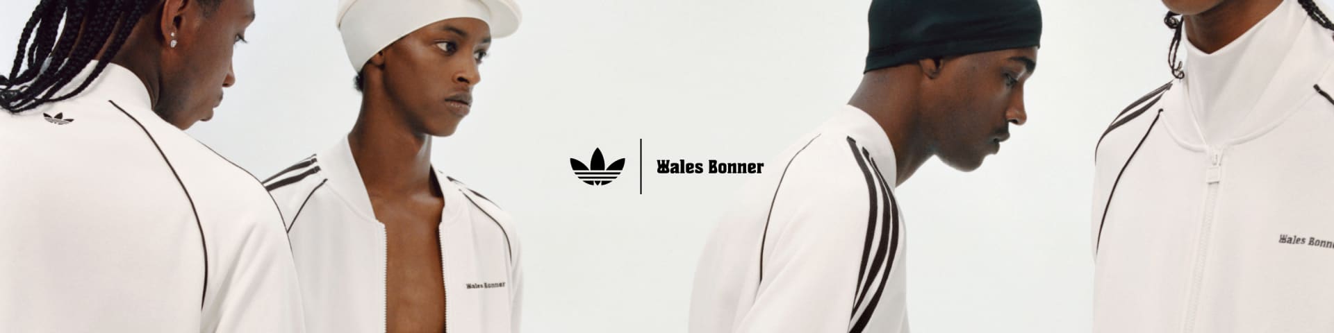 Four models are posing against a white background, all wearing white outfits from the adidas Originals by Wales Bonner collection.