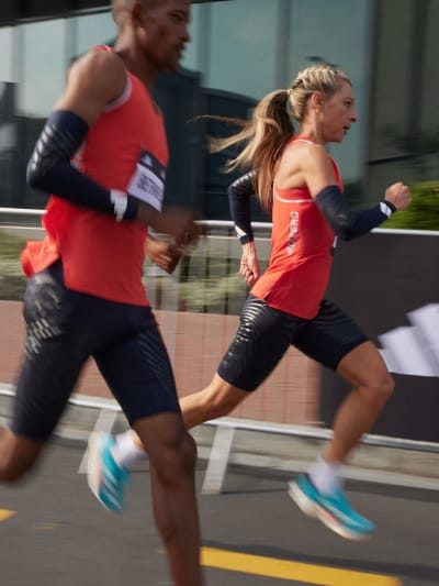Man and woman running in adizero shoes