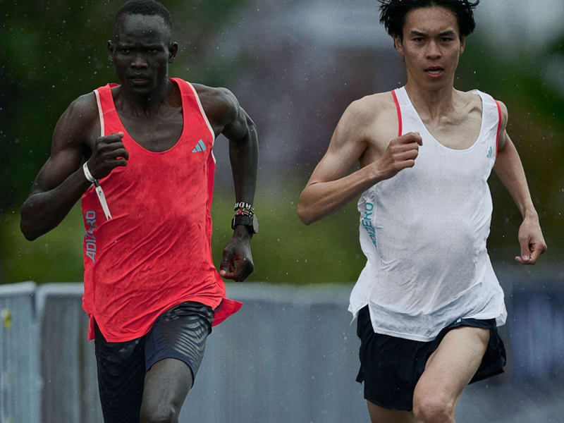 Two athletes run together in training.
