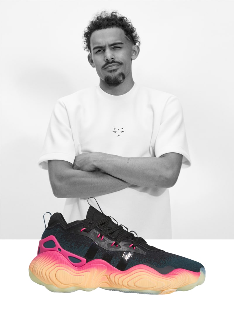 Trae Young portrait behind side profile view of black and orange shoe