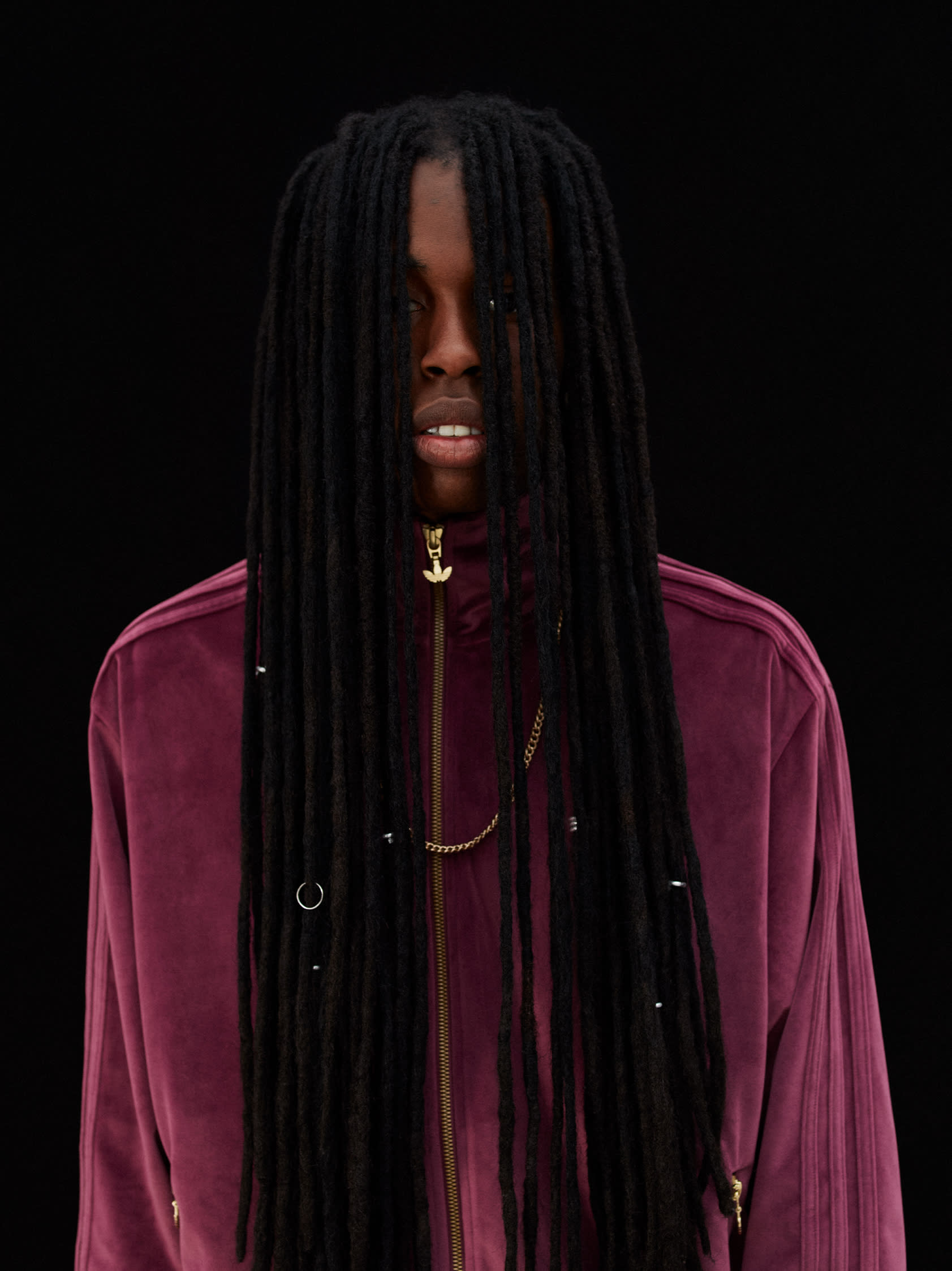Man wearing contemporary pink adicolor tracksuit