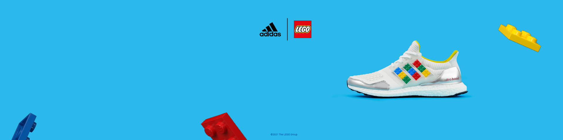 ultraboost dna plates trainers on a grey background with floating lego bricks