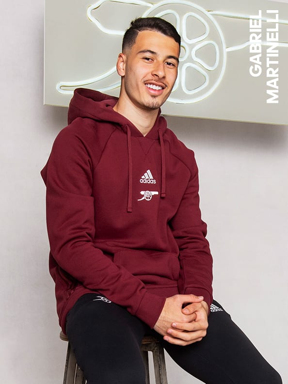 Male and female players wearing the Arsenal Travel Collection