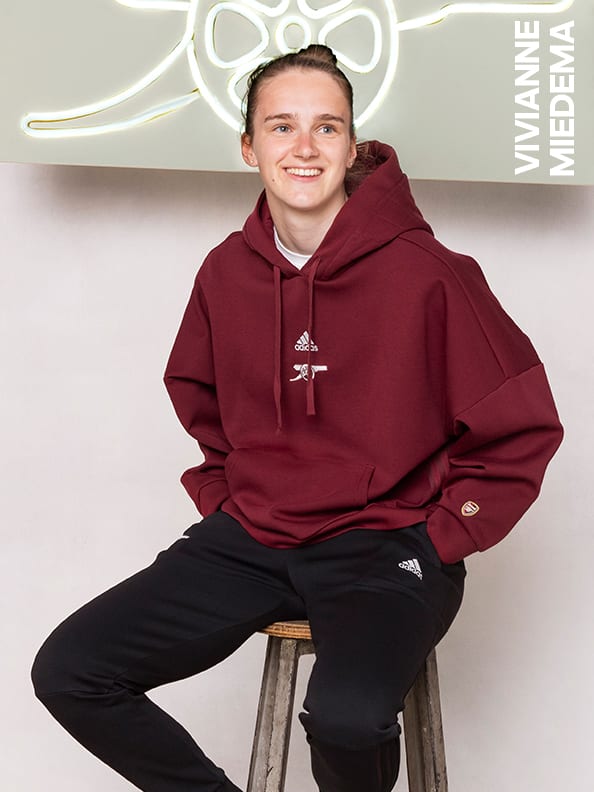 Male and female players wearing the Arsenal Travel Collection