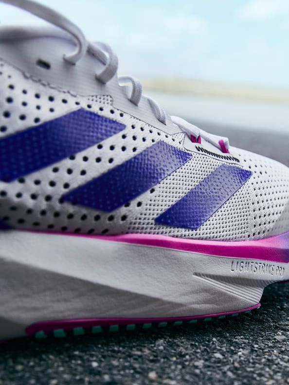 An extreme closeup of the mens Adizero SL in white. The words lightstrike pro are visible on the sole