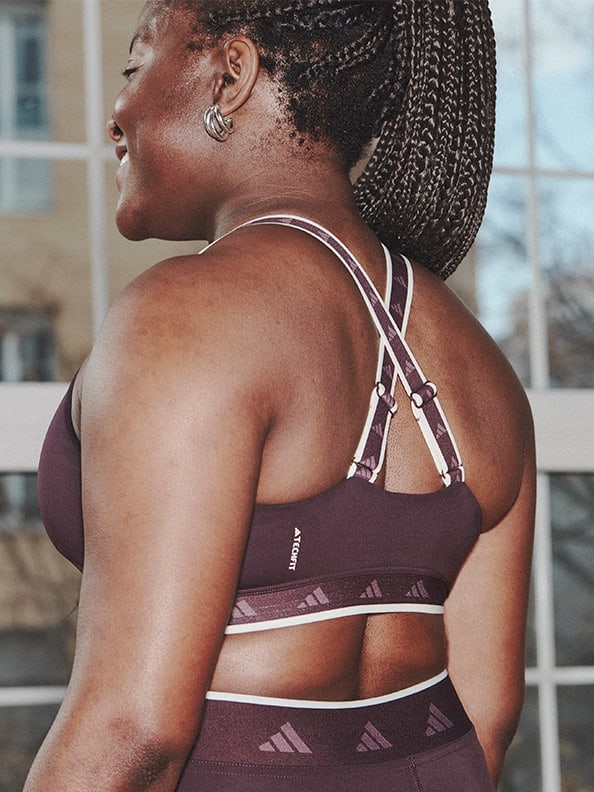Image of the back of a model wearing a plum bra and tights co-ord