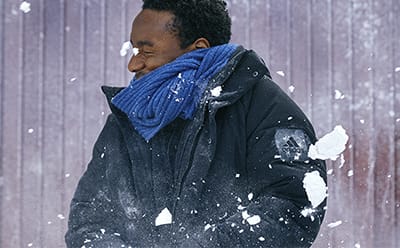 Man getting hit by a snowball.