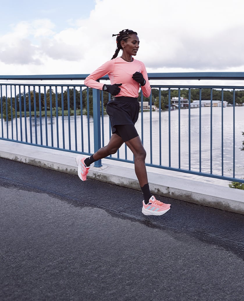 Woman running with the adidas Adistar running shoe