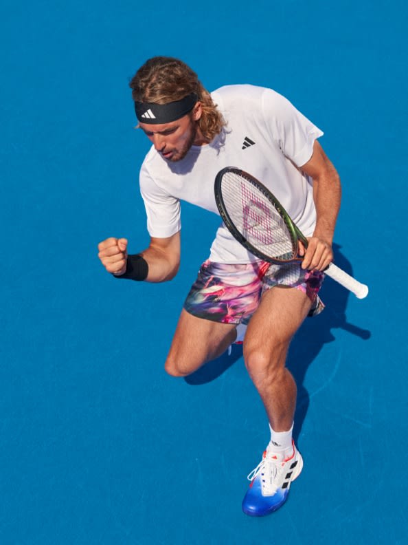 Male tennis player holding a fist in victory