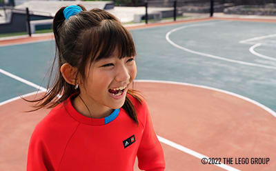Smiling girl on a colourful basketball court