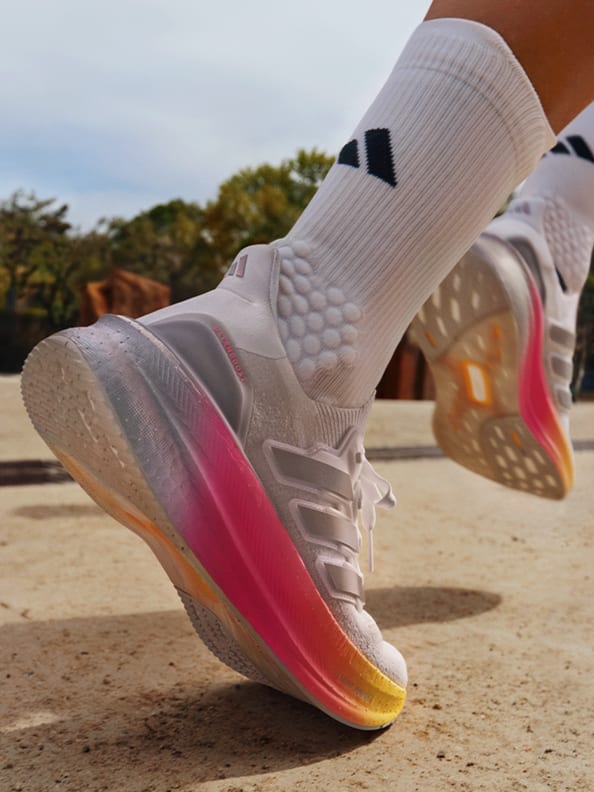 Close-up image of a leg running outdoors wearing the Ultraboost 5.