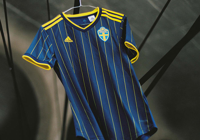The new Sweden Away jersey is shown here. Its timeless design contrasts bright yellow stripes against an indigo backdrop.