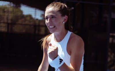 A woman wearing the new adidas padel gear and playing padel.