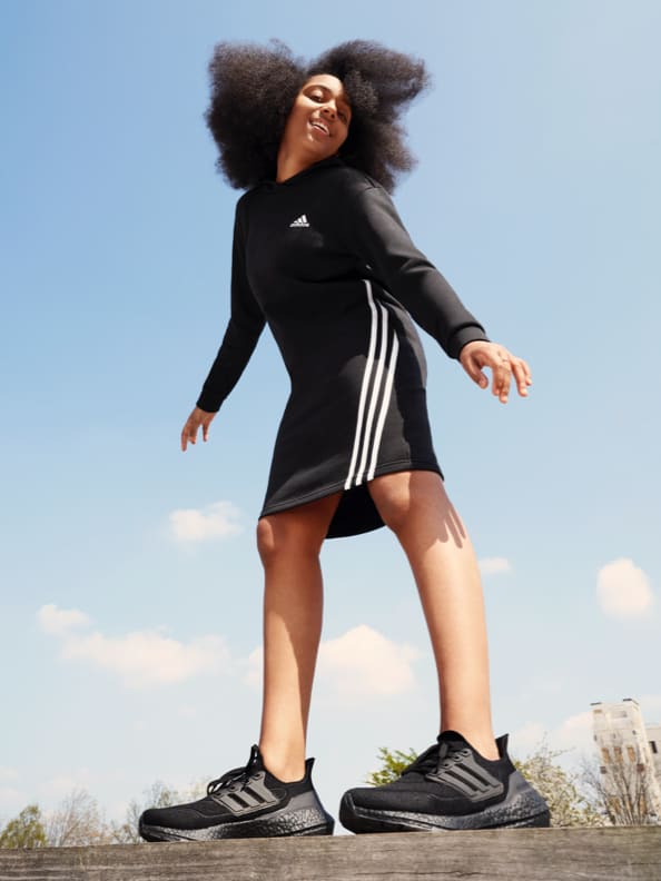 WNBA player Erica Wheeler and English footballer Noni Madueke wear adidas clothing with the iconic three stripes.