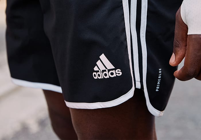 A man is wearing Primeblue shorts