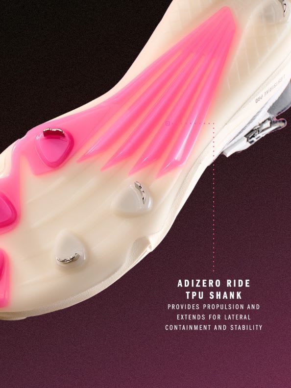 The image shows a close-up view of a white athletic shoe with bright pink accents and a transparent sole that reveals a pink internal structure.